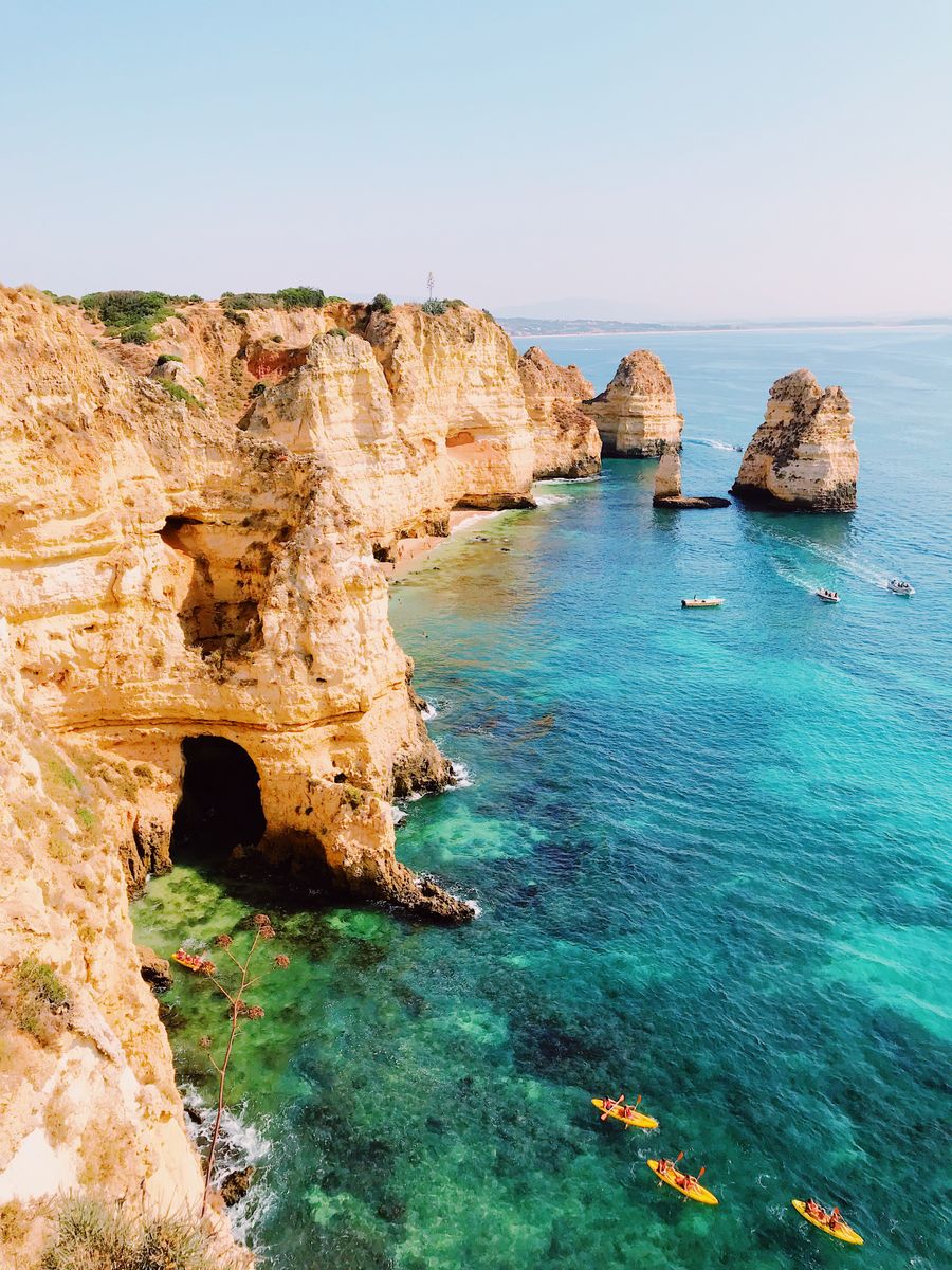 Caiaques entre as falésias douradas e a água turquesa de Lagos, no Algarve